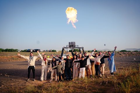 Group photo in front of the burner flame at sunrise