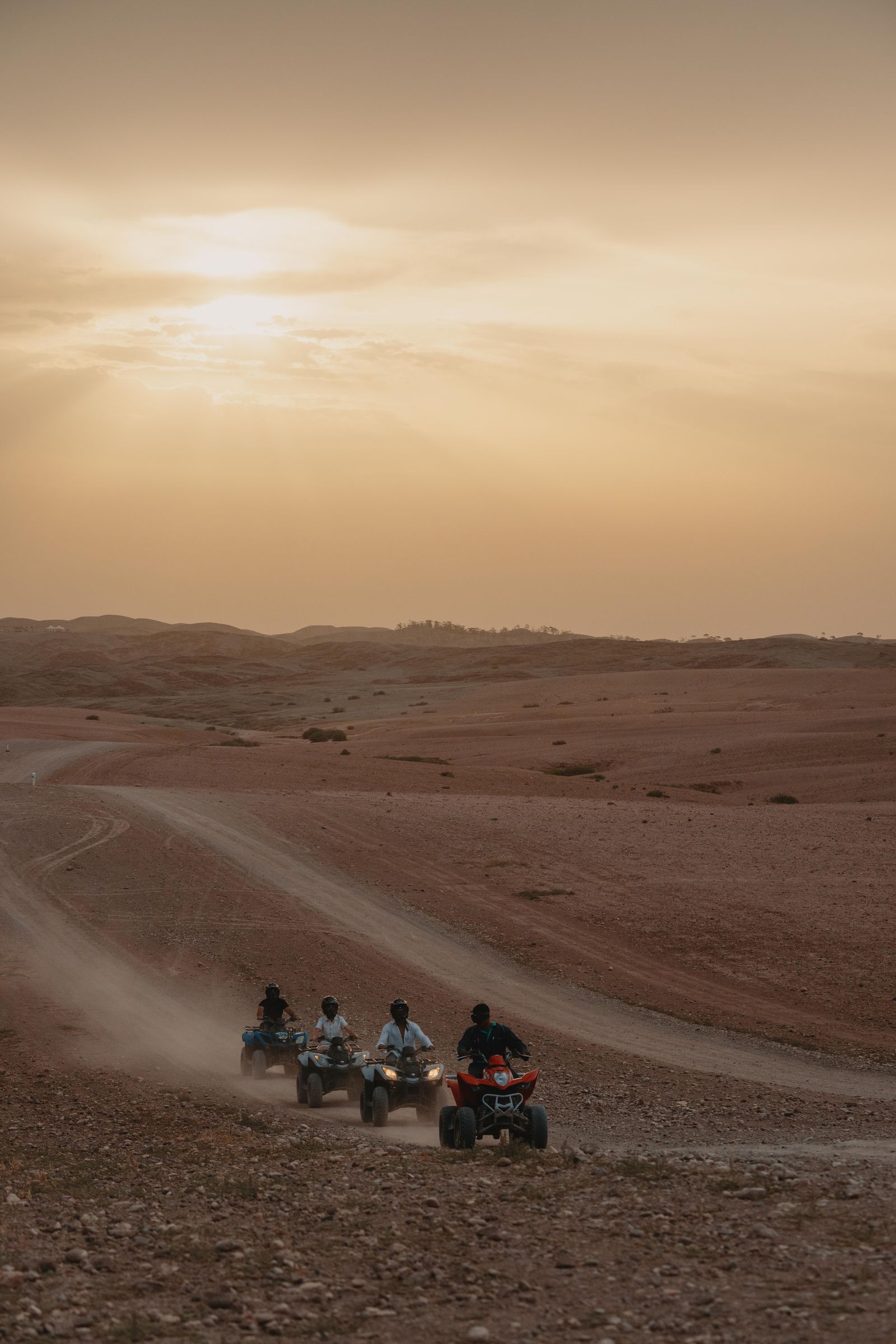 A couple beside parked quad bikes at the end of a ride on the Agafay plateau